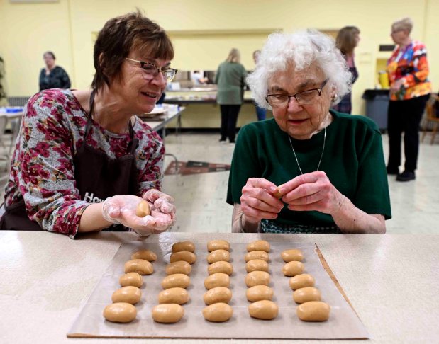 Eileen Linn, left, of Dallas, Texas, visited with her mother, Ruth Lenart of Exeter Township, and stayed specifically to help with the chocolate-covered Easter eggs at Schwarzwald United Church of Christ on Thursday, Feb. 19. 2026. (BILL UHRICH/READING EAGLE)