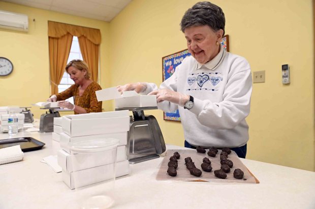 Pam Clark, right, and Joanne Bollendorf, both of Exeter Township, box chocolate-covered Easter eggs at Schwarzwald United Church of Christ on Thursday, Feb. 19. 2026. (BILL UHRICH/READING EAGLE)