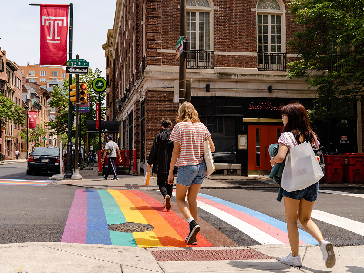 People walk across the Rainbow Crosswalk at the intersection of South 13th and Locust streets in Philadelphia.