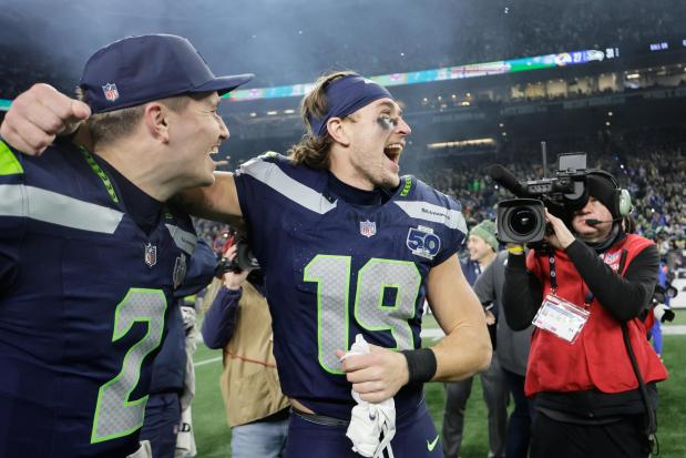 Seattle Seahawks wide receiver Jake Bobo (19) celebrates with quarterback Drew Lock (2) after the NFC Championship NFL football game against the Los Angeles Rams, Sunday, Jan. 25, 2026, in Seattle. (AP Photo/John Froschauer)
