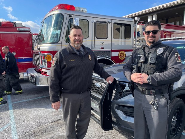Olyphant Police Chief James DeVoe, left, and Officer Tom Sakosky assisted with the coat giveaway. (Courtesy of Lauren Telep)