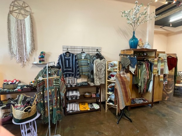 Clothing, including hand-knitted items created by Beth Ann Zero and Melissa Martini, are displayed for sale at the Wonderstone Gallery in Dunmore. (Danielle Karwaski/For The Valley Advantage)