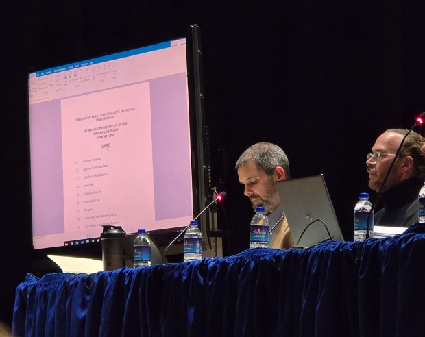 Attorney Jeffrey Esch McCombie, left, Nick Farris, the director of acquisitions and director of data center development at Provident Realty Advisors, respond to questions during a public hearing at the Valley View High School in Archbald on Wednesday, Feb. 11, 2026. (FRANK WILKES LESNEFSKY / STAFF PHOTO)