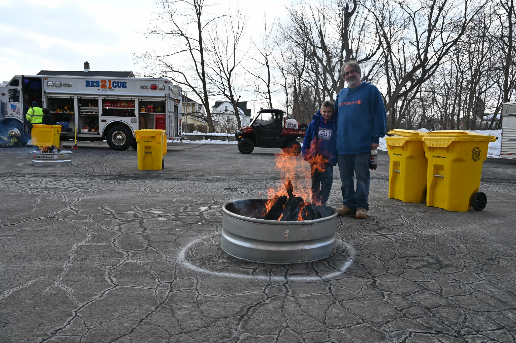 Eric Mecca and his son Miles warm up at a...