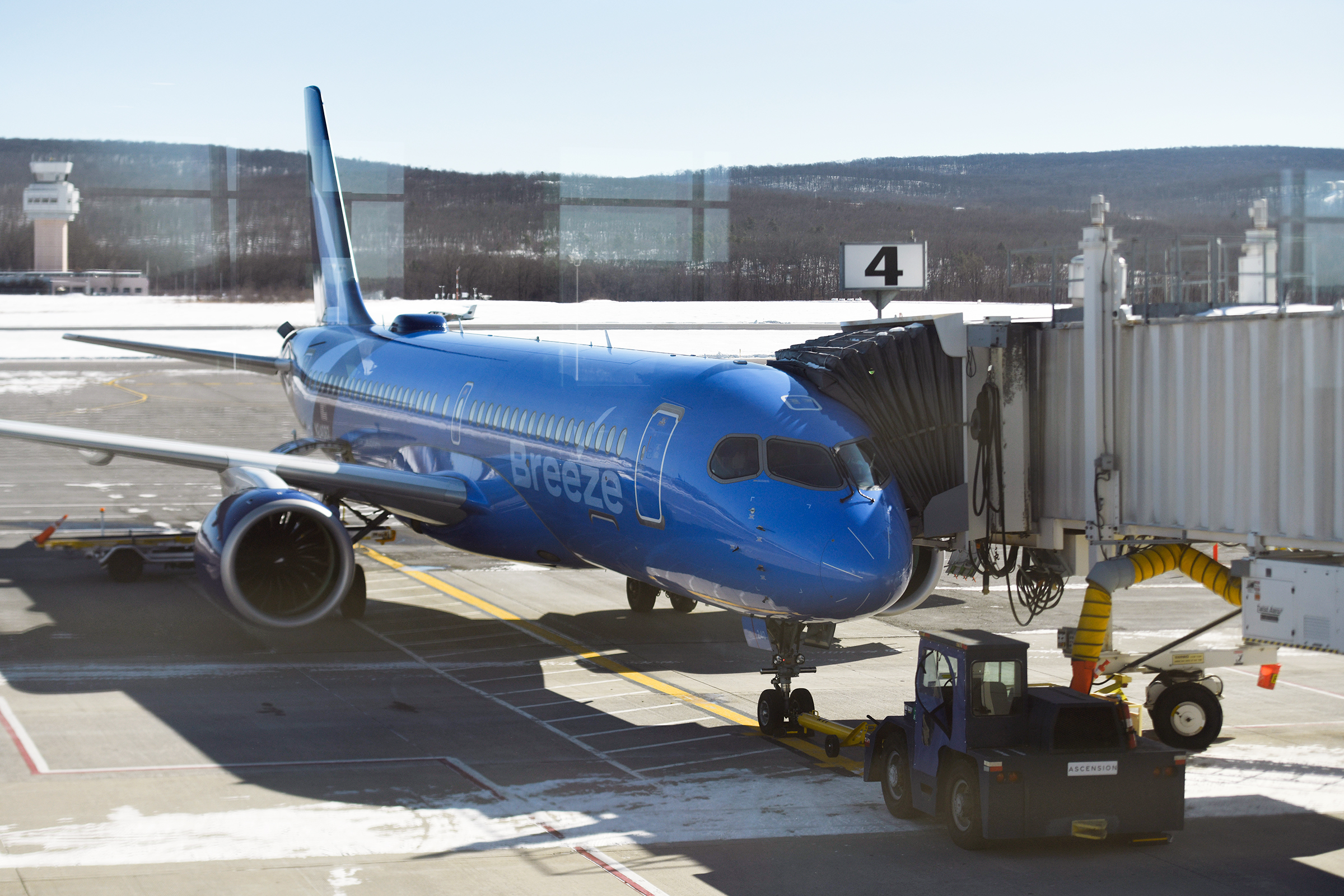 A plane from Breeze Airways loads passengers before departing to...