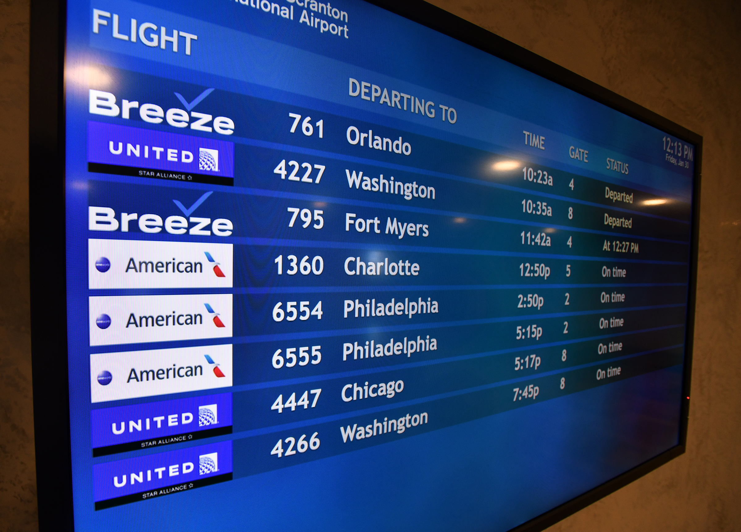 Flight information is displayed on a monitor in the Wilkes-Barre...