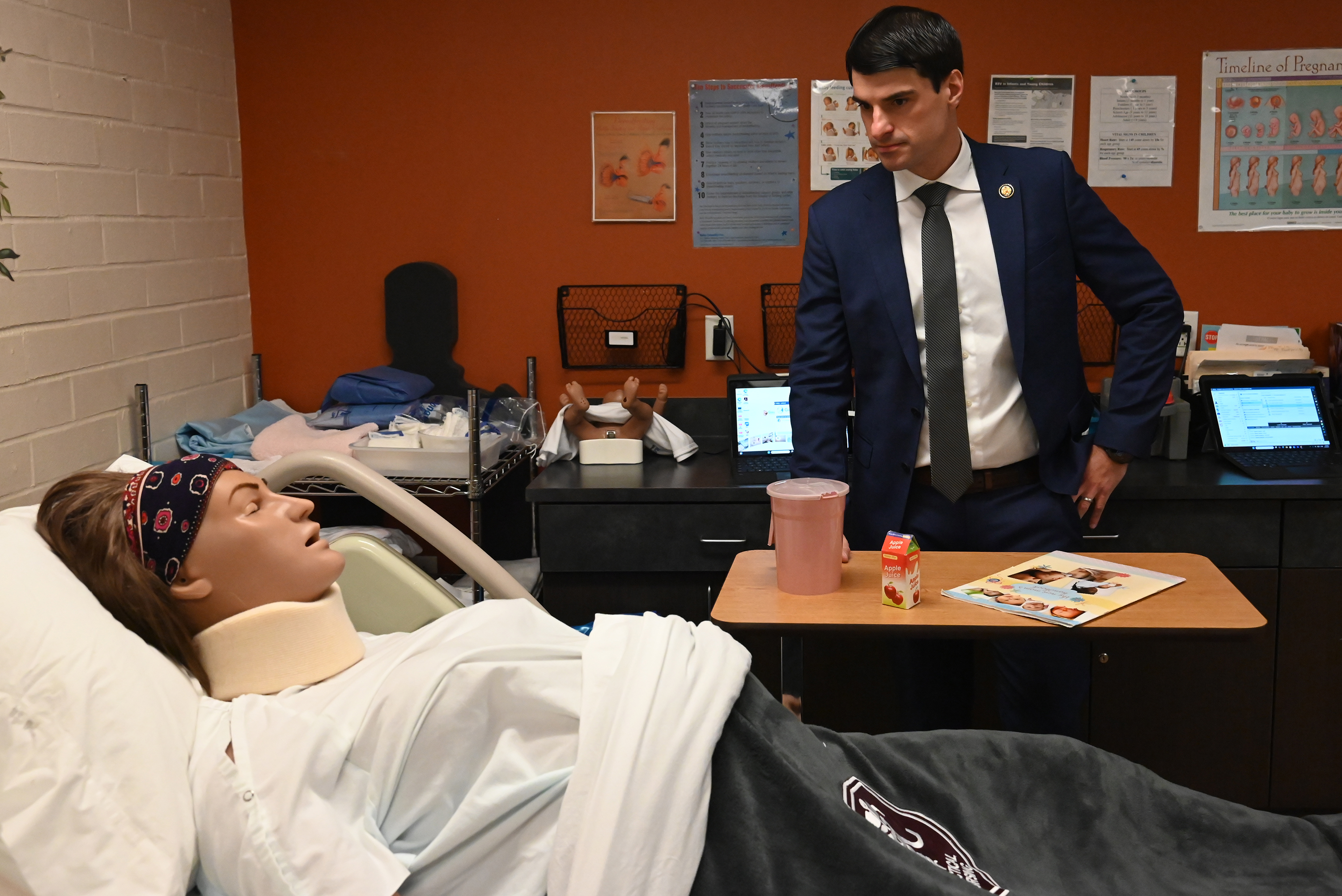 U.S. Rep. Rob Bresnahan looks at medical simulators at the...