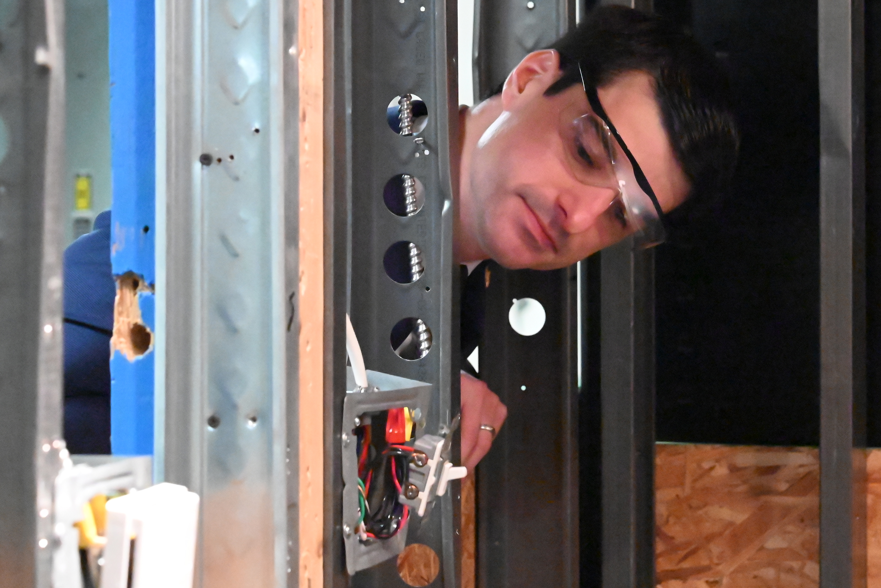 U.S. Rep. Rob Bresnahan looks at students’ electrical handiwork at...