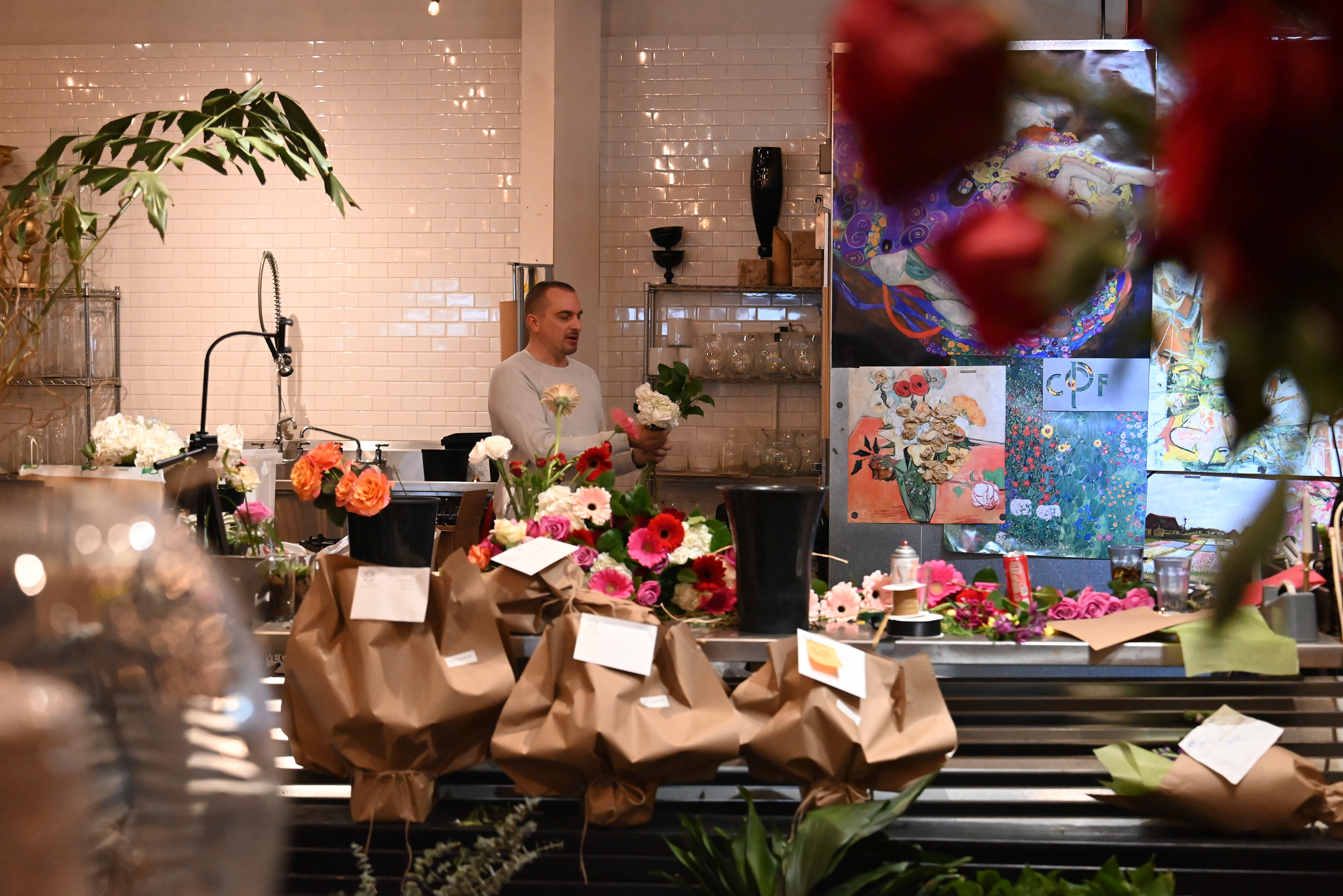 Owner Dorian Butovich arranges flowers at Central Park Flowers in...