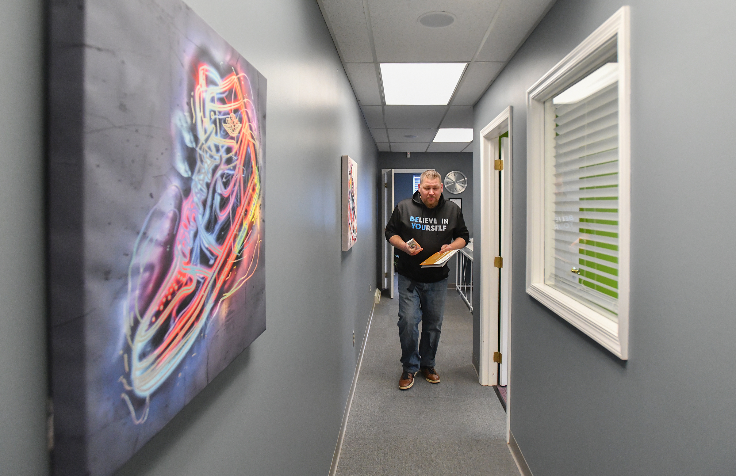 Founder of NextGen Counseling Jonathon Wasp walks through the hallway...