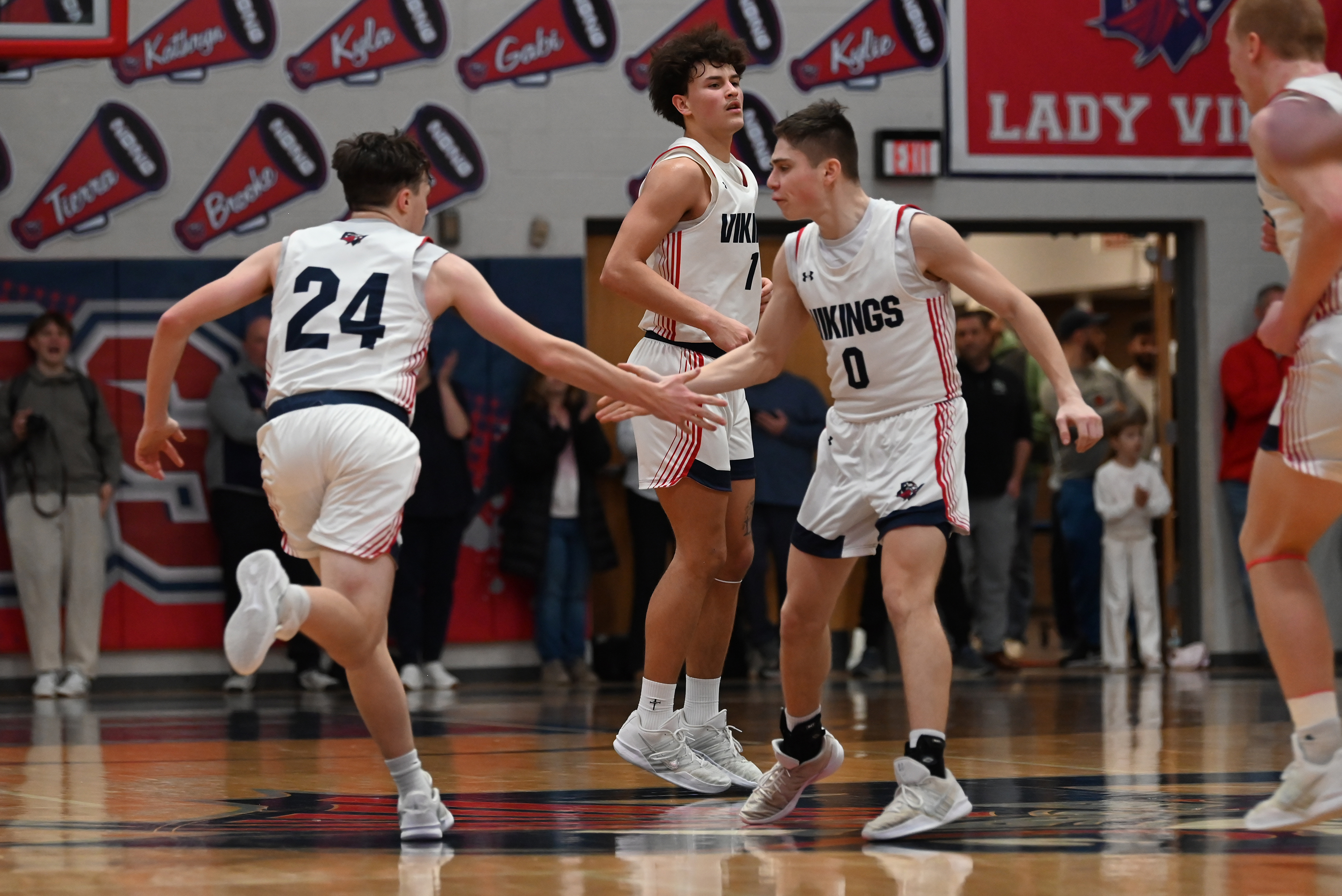 Riverside’s Michael Schmilfenig (0) shares a high five with teammate...