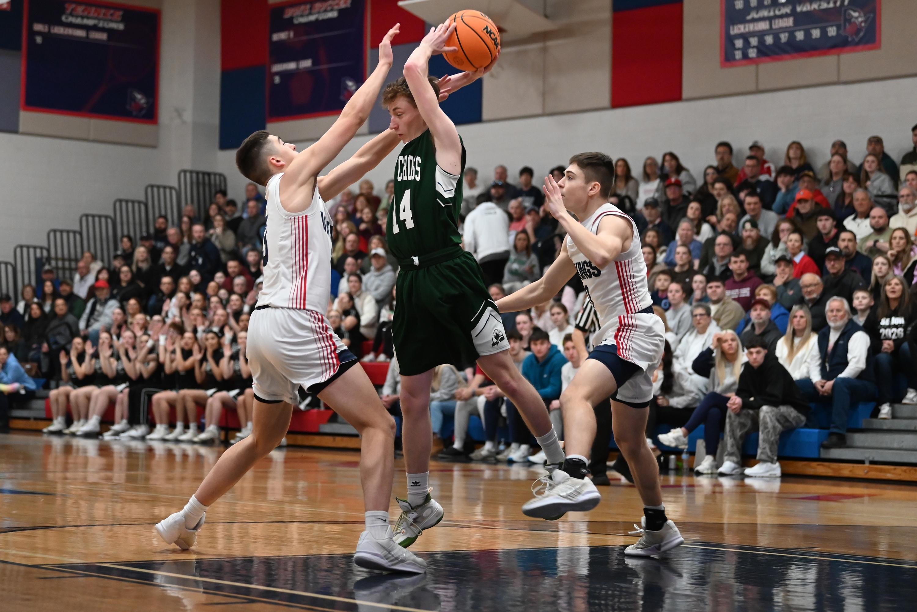 Riverside’s Nico Antoniacci and Riverside’s Michael Schmilfenig defend Holy Cross’...