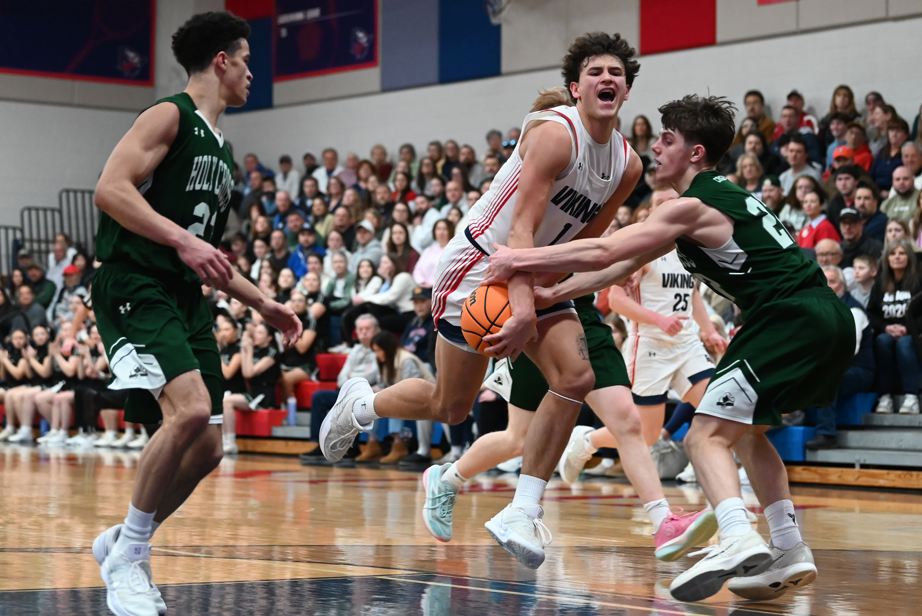 Holy Cross’ Jack Alpert defends Riverside’s Brayden Rose during the...