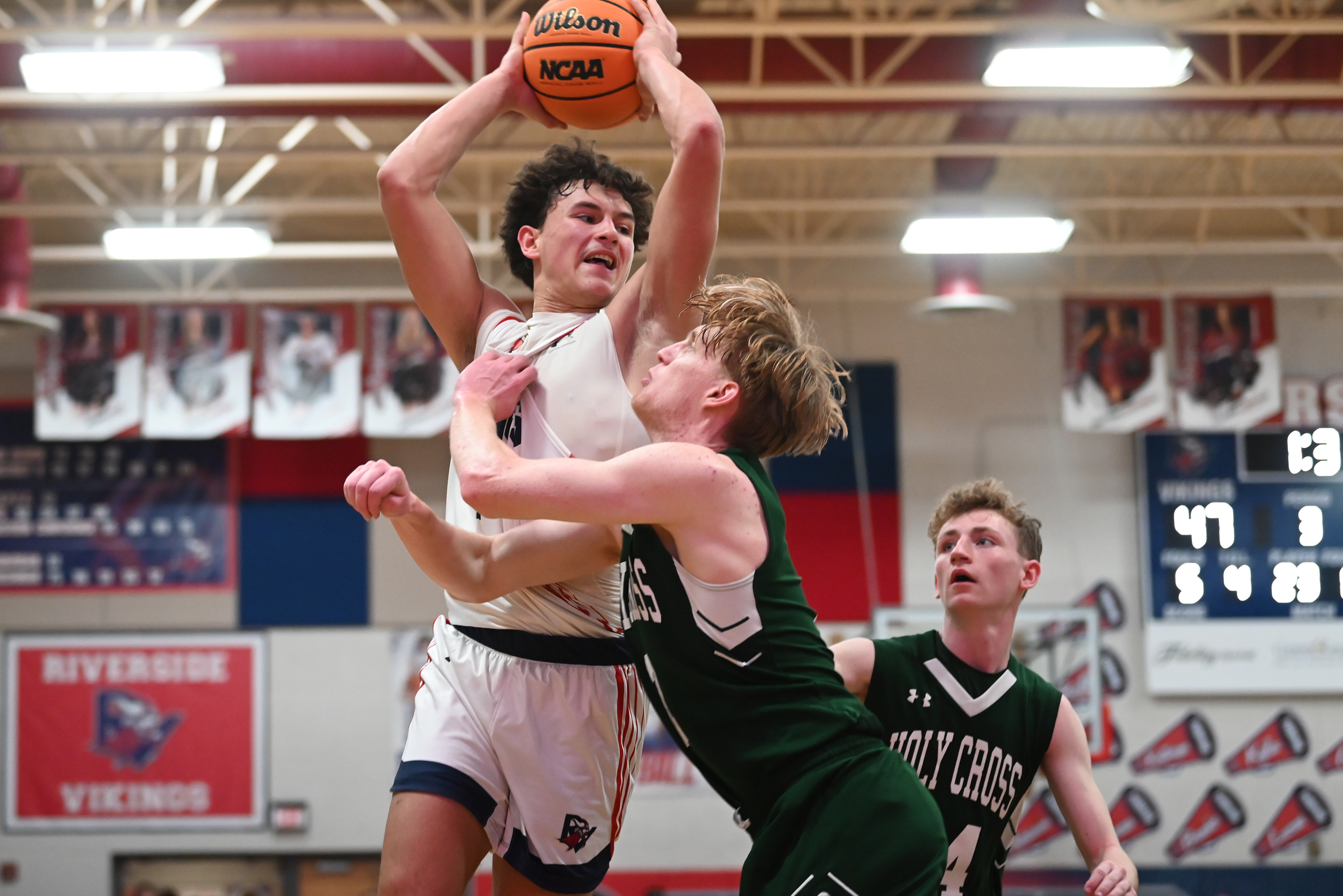 Holy Cross’ Adam Badyrka defends Riverside’s Brayden Rose during the...