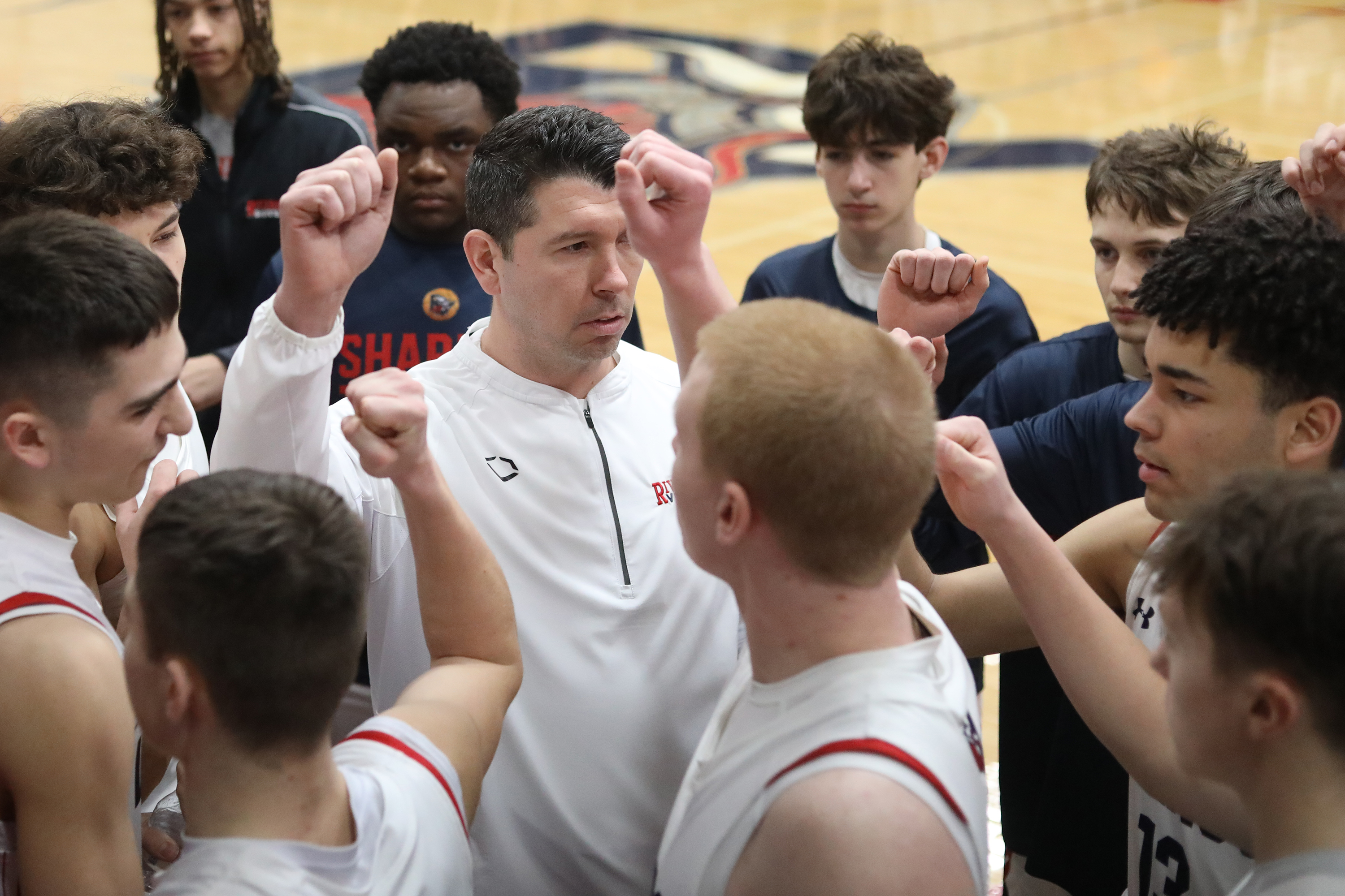Riverside’s head coach Josh Aniska rallies with his team before...