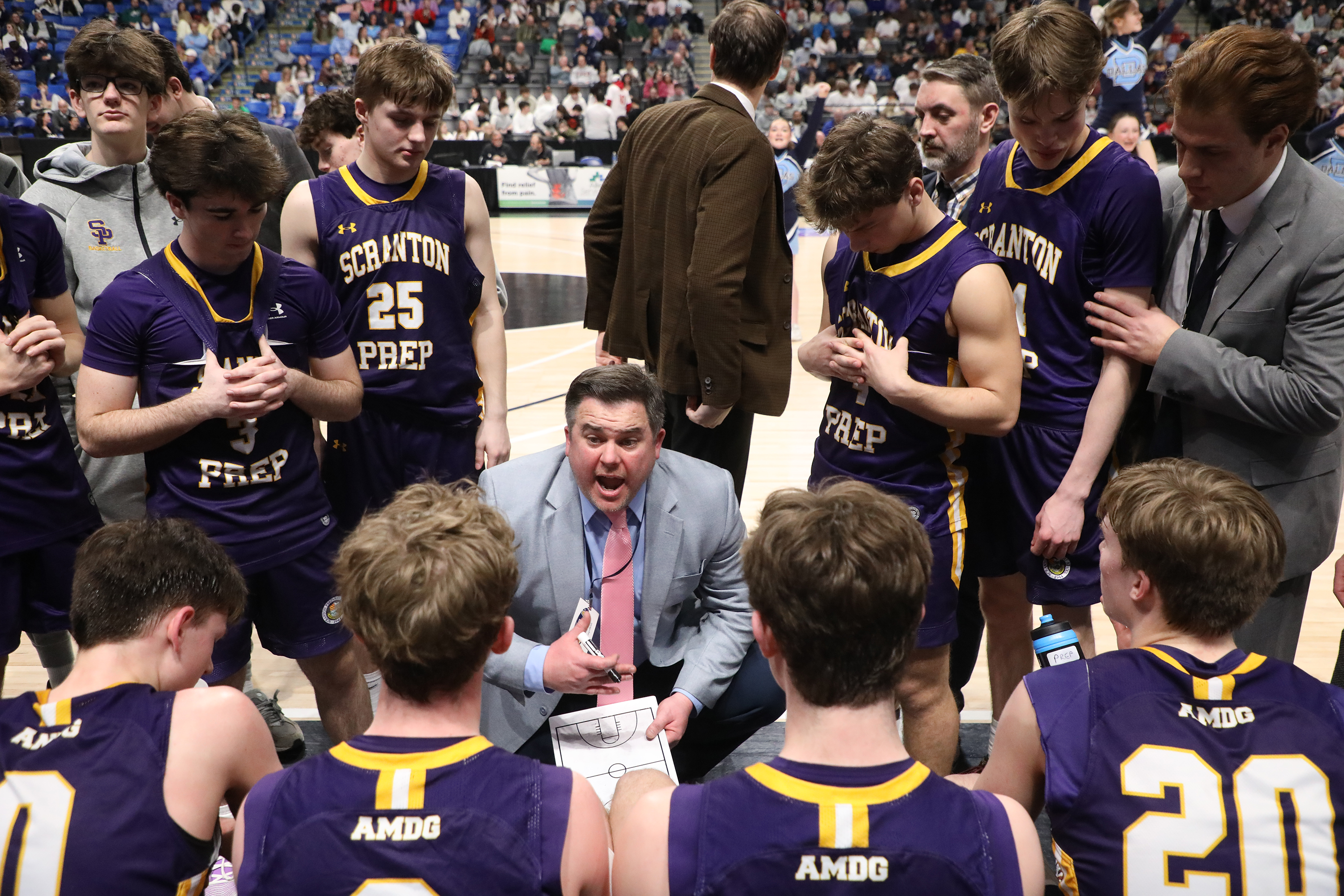 Scranton Prep’s head coach Larry Reagan talks to his players...