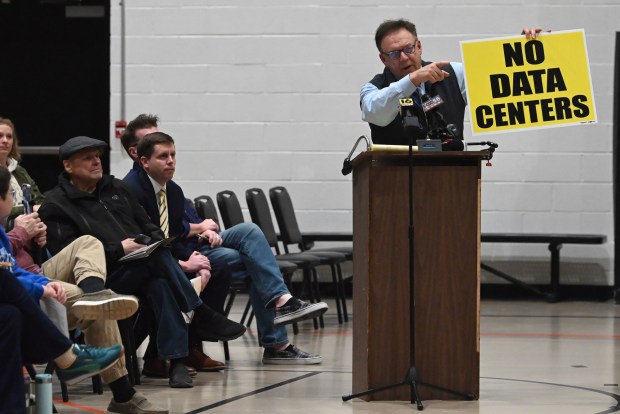 Lackawanna County Controller Gary DiBileo points to where he left a box full of "No Data Centers" signs during the public hearing on a zoning ordinance to regulate data centers in Dickson City at the Dickson City Civic Center on Thursday, Feb. 12, 2026. (REBECCA PARTICKA/STAFF PHOTOGRAPHER)