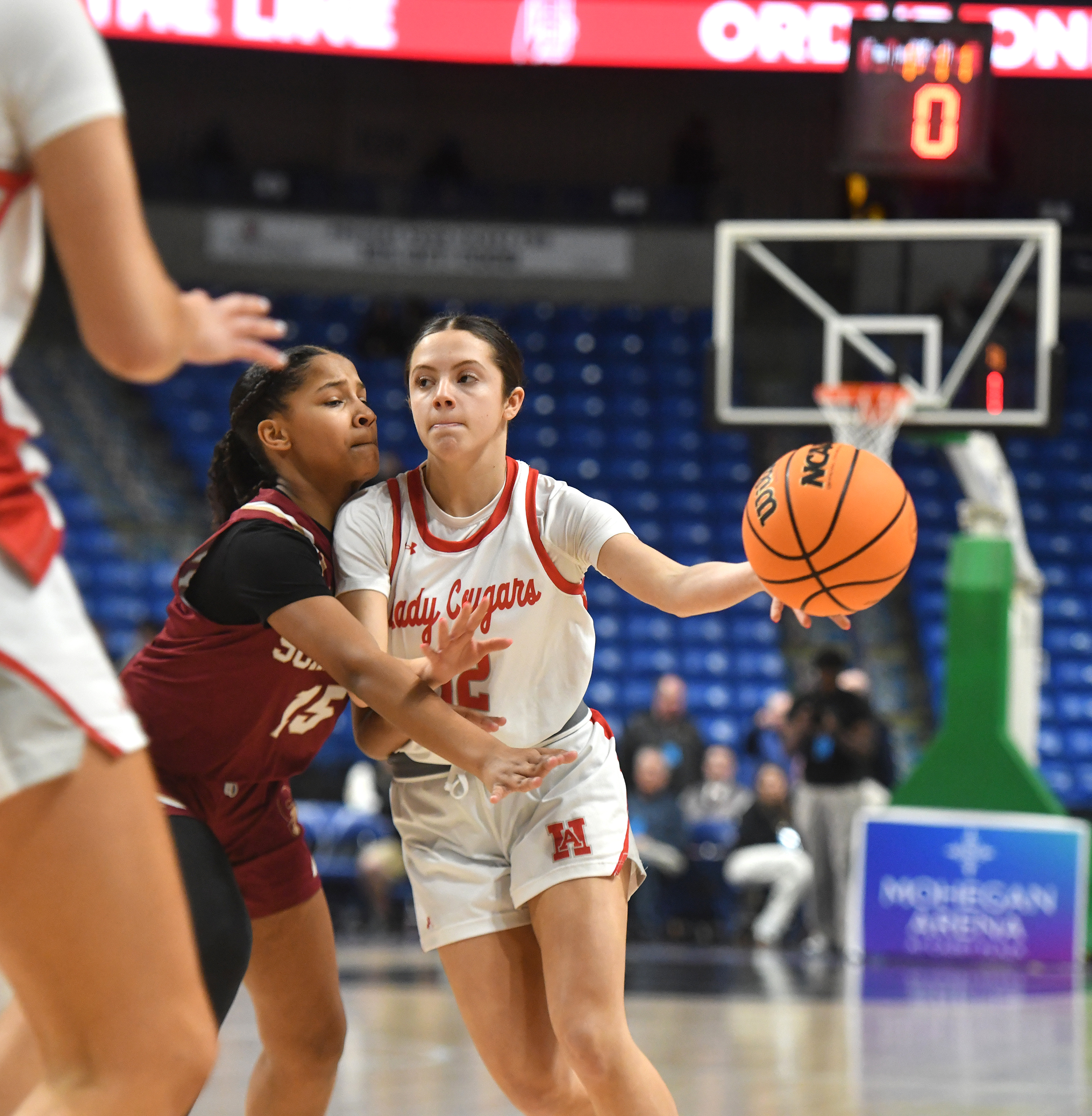 Hazleton Area’s Sofia Rodgers (12) passes through the defense of...