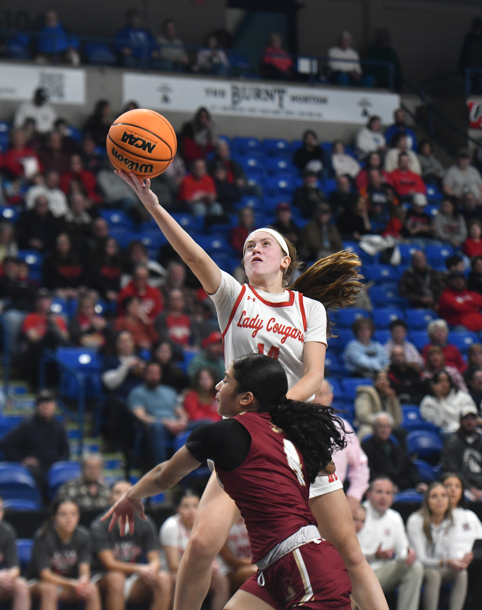 Hazleton Area’s Kaitlyn Bindas scores over Scranton’s Bianca Perez during...