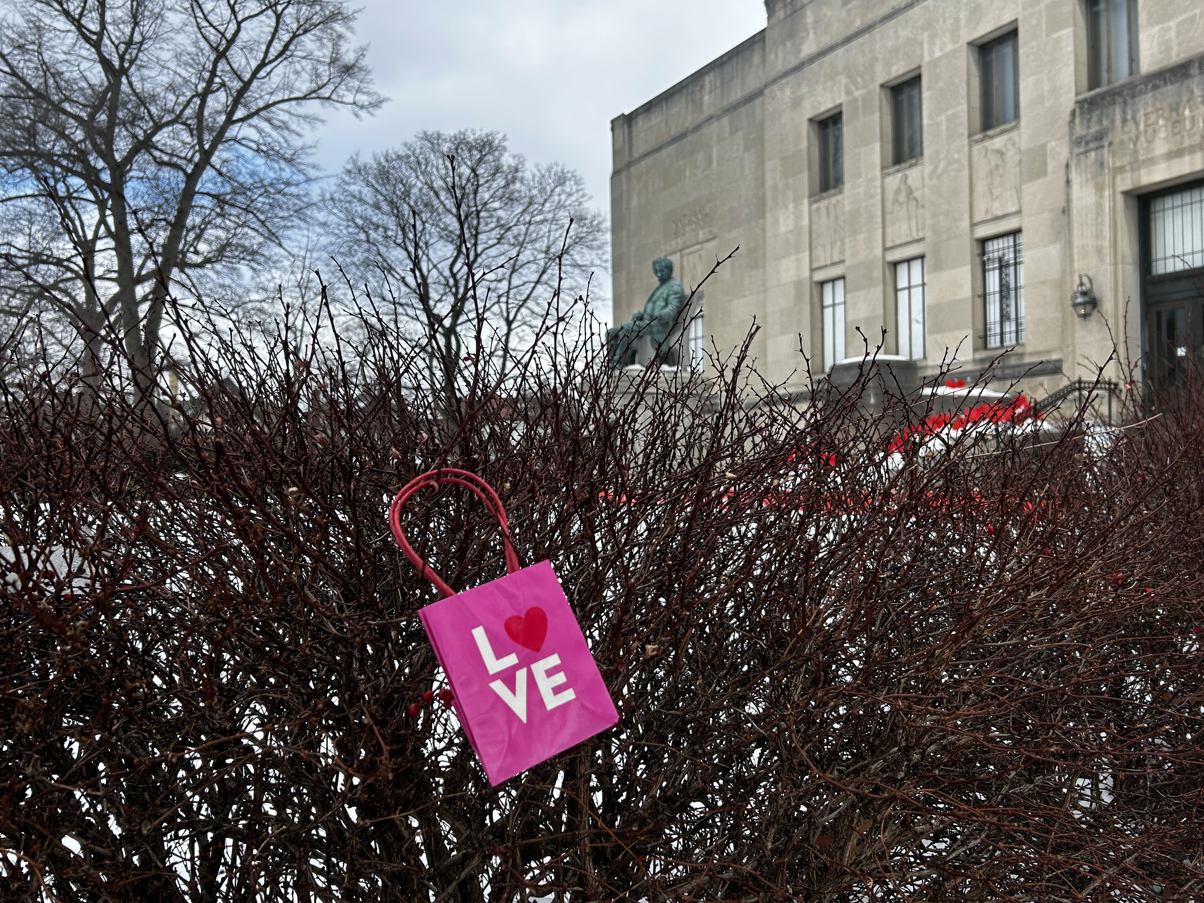 A bag that depicts the word “LOVE'” hangs in the...