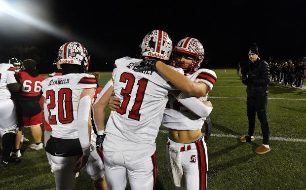 North Pocono quarterback Chase Zimmerman hugs teammate Evan Wolff (31) after defeating Bishop Shanahan in a PIAA Class 4A first-round game at Jack Mancini Field in Downingtown Friday, Nov. 14, 2025. (SEAN MCKEAG / STAFF PHOTOGRAPHER)