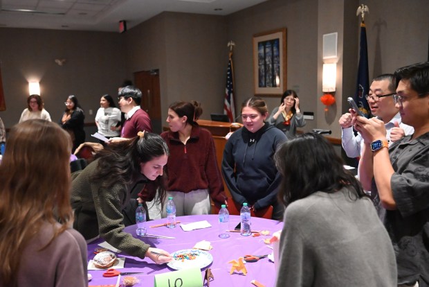 Attendees participate in a chop stick challenge, attempting to scoop up M&M's with chopsticks, during the Asian New Year Festival and Workshop at the University of Scranton on Thursday, Feb. 19, 2026. (REBECCA PARTICKA/STAFF PHOTOGRAPHER)