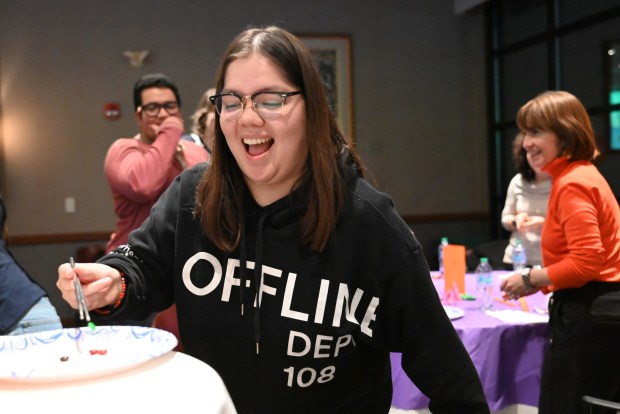 Spanish instructor Agustina Santivanez successfully delivers a M&M to the center table during the chopstick challenge portion of the Asian New Year Festival and Workshop at the University of Scranton on Thursday, Feb. 19, 2026. (REBECCA PARTICKA/STAFF PHOTOGRAPHER)