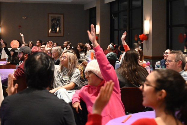 Attendees raise hands to answer trivia questions after listening to the presentation on Japanese New Years traditions during the Asian New Year Festival and Workshop at the University of Scranton on Thursday, Feb. 19, 2026. (REBECCA PARTICKA/STAFF PHOTOGRAPHER)