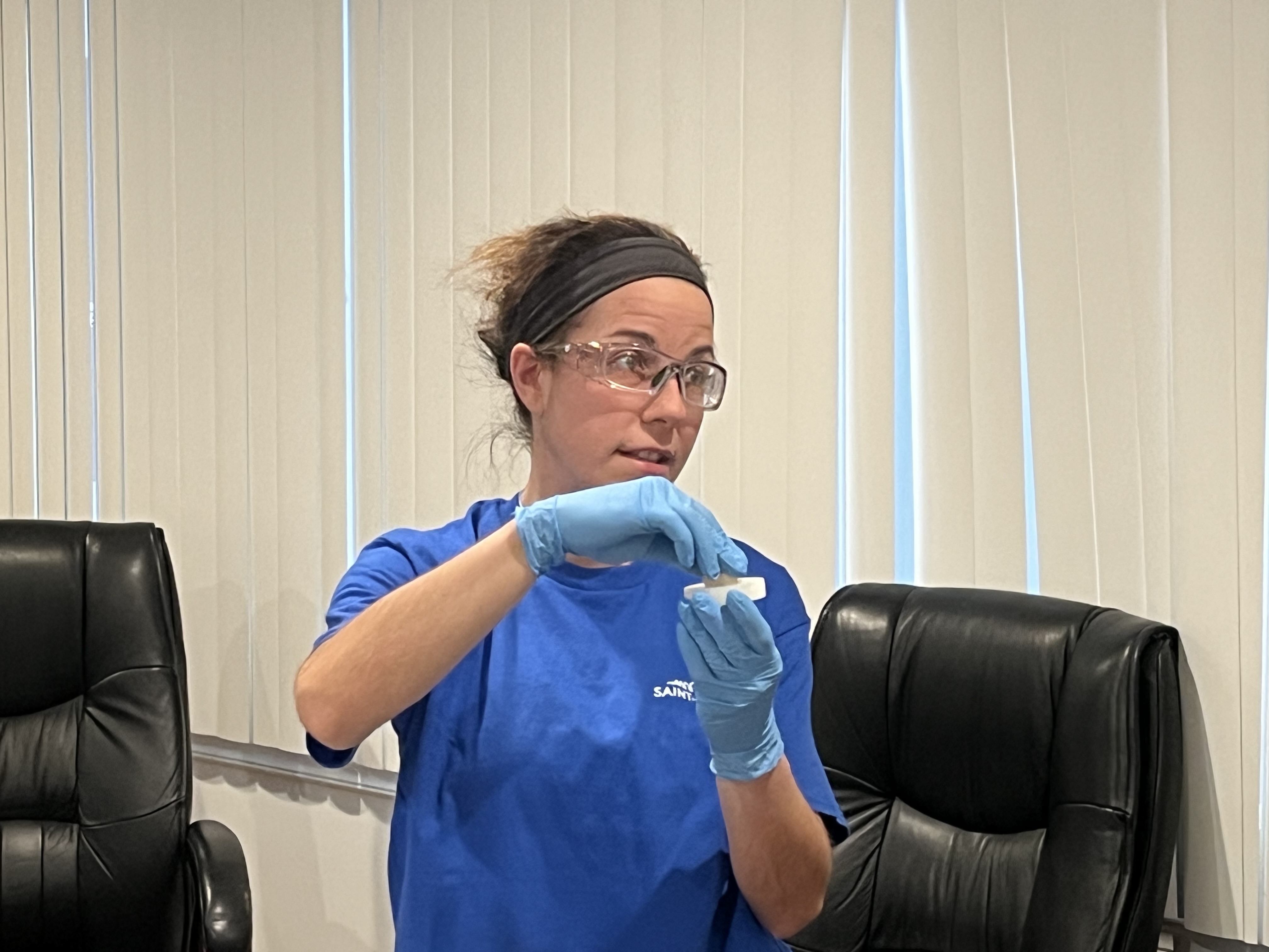 Stephanie Gorney, a senior particle process operator for Saint-Gobain, demonstrates...