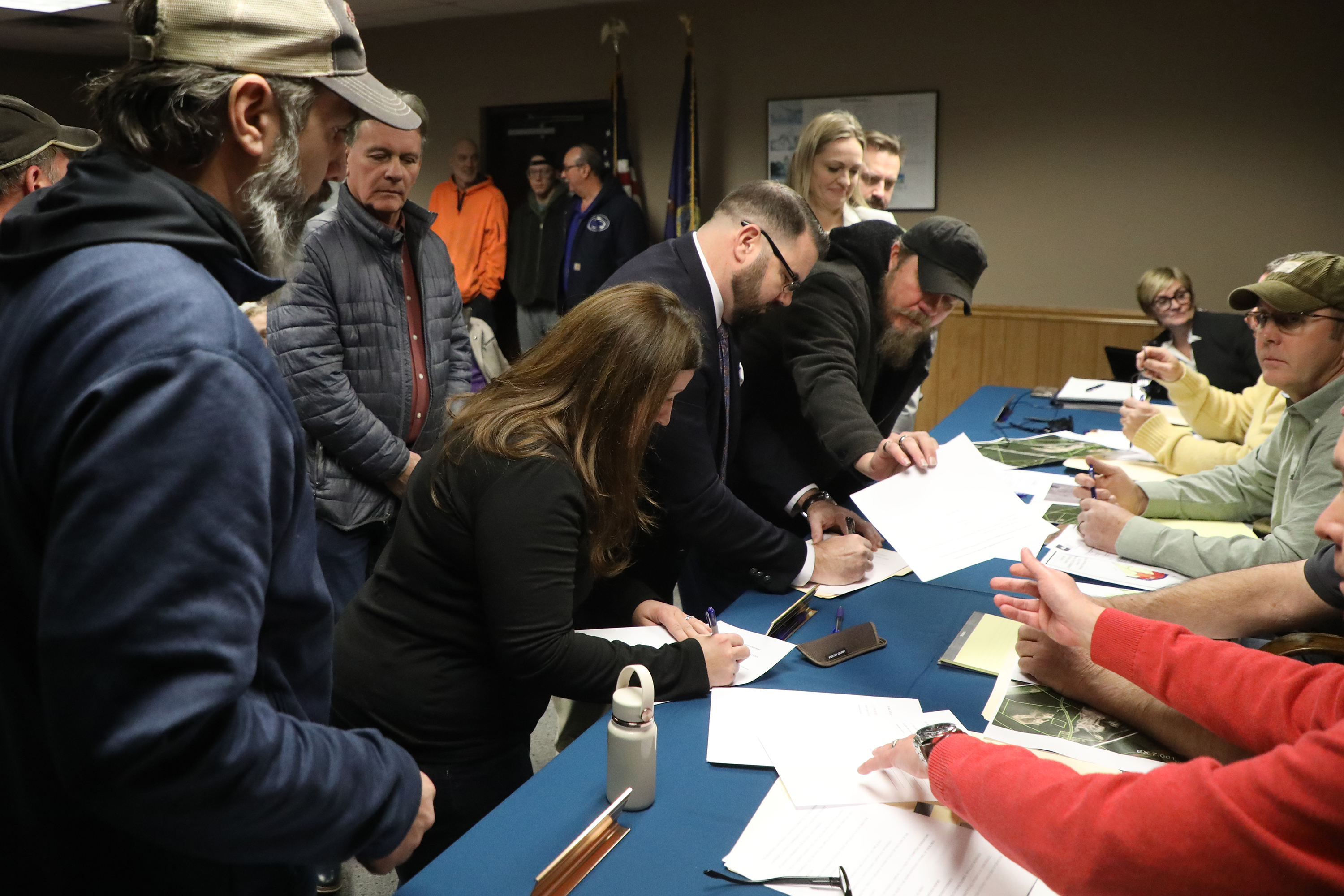 Community members fill out objector forms to voice their opposition...