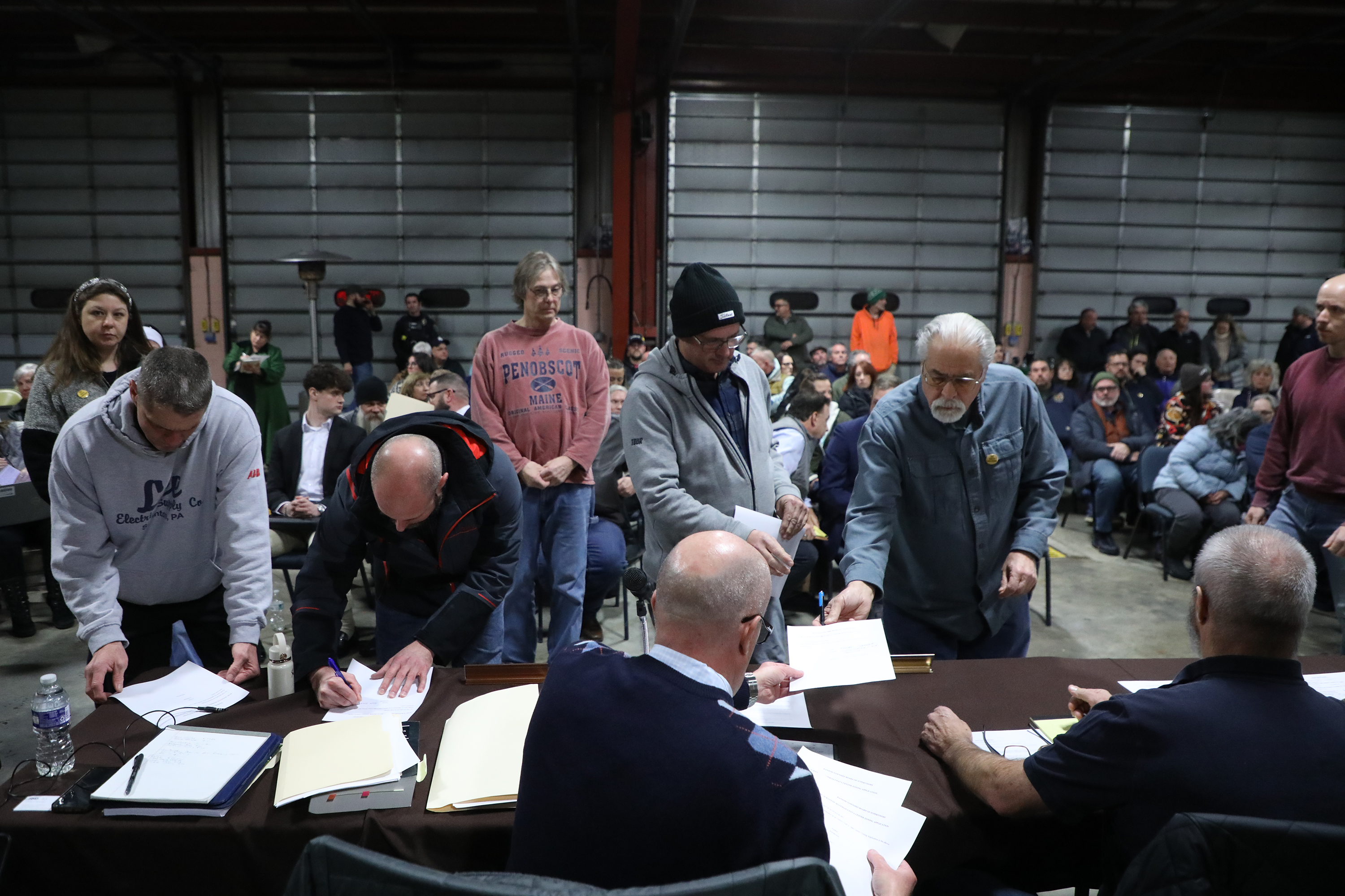 Community members fill out objector forms during the Ransom Twp....