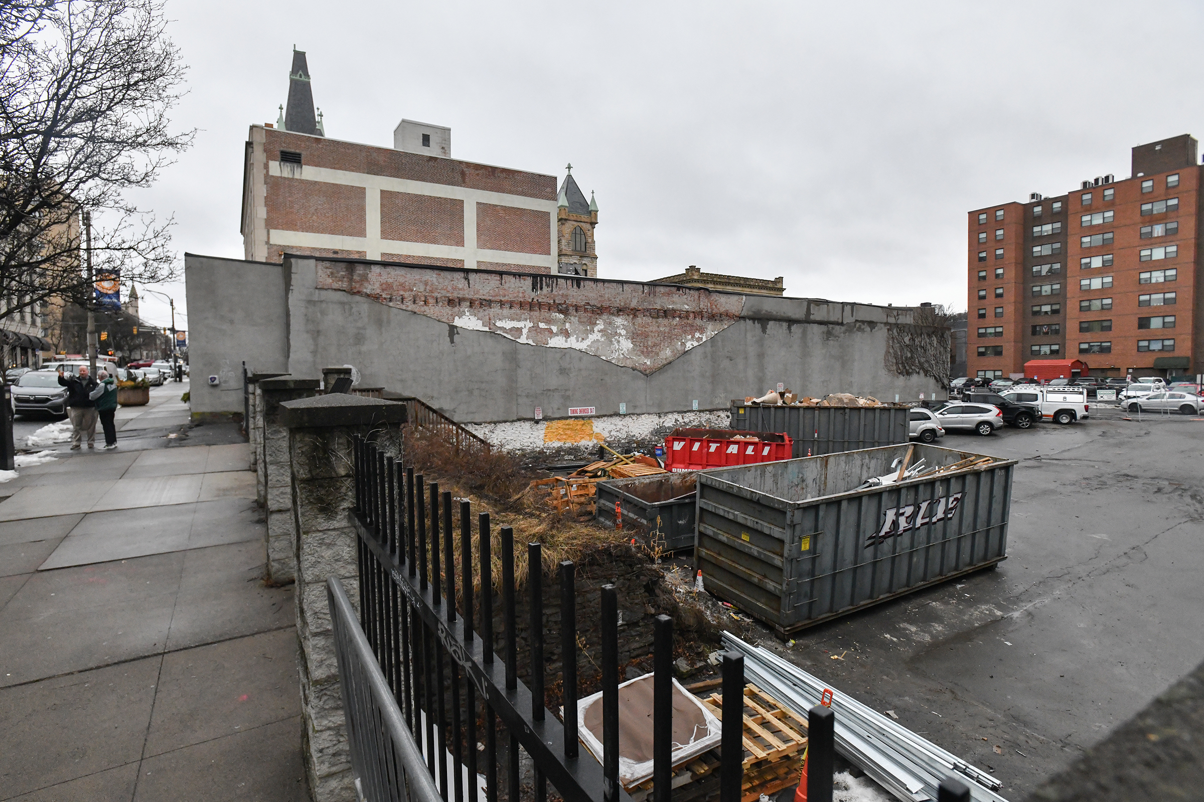 Dumpsters from RLE Enterprises occupy the parking lot of the...