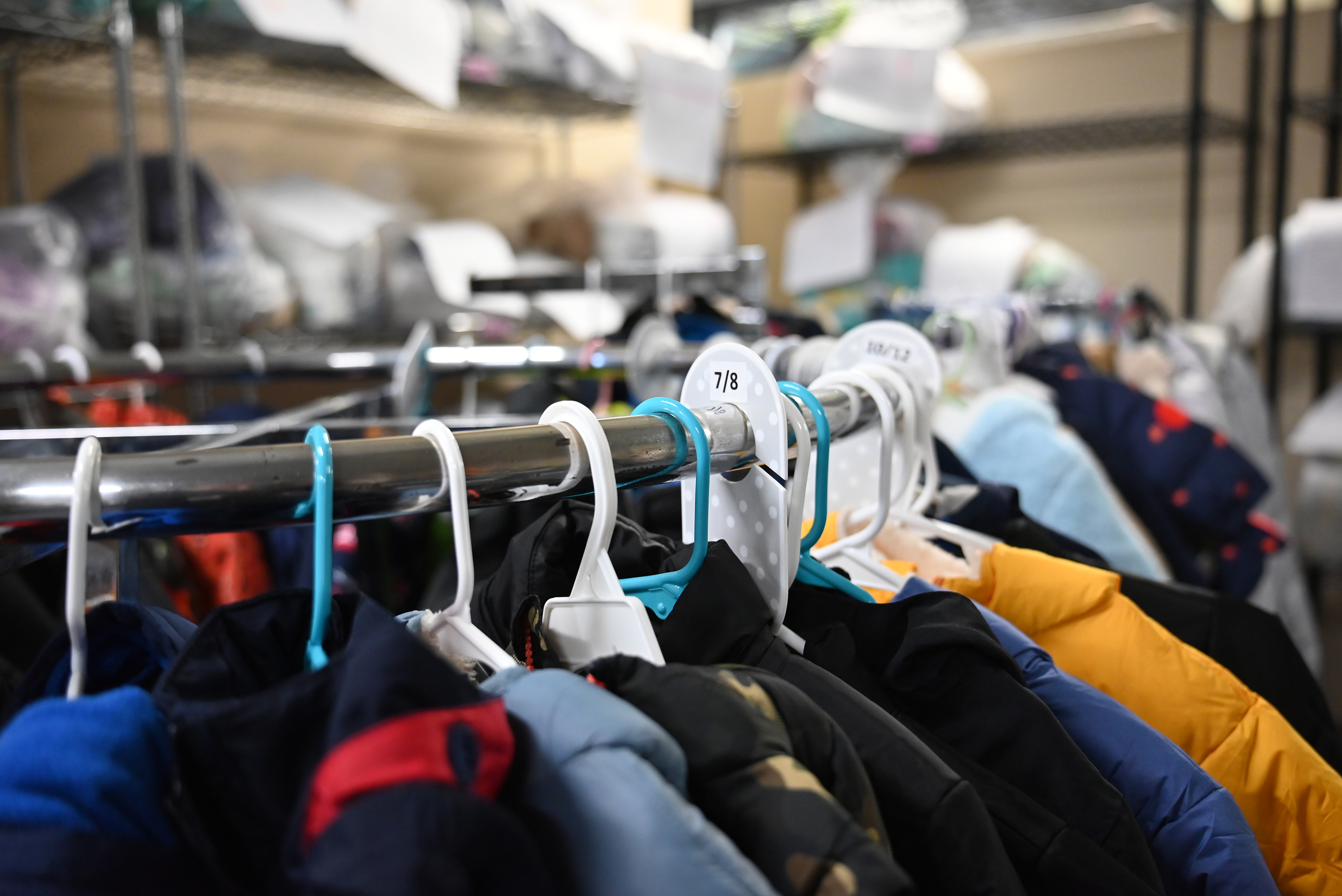 Coats sit on a rack during the children's clothing drive....