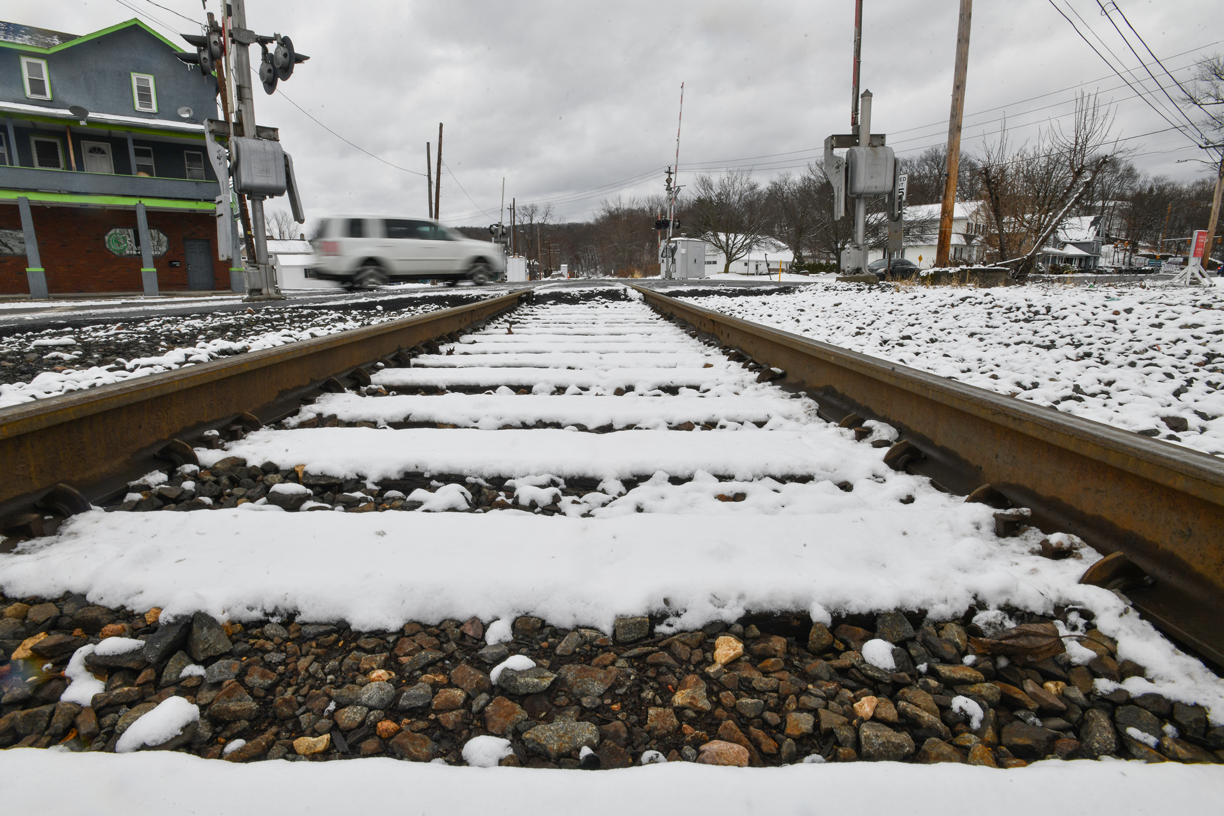 A vehicle crosses the railroad tracks on Main St. in...