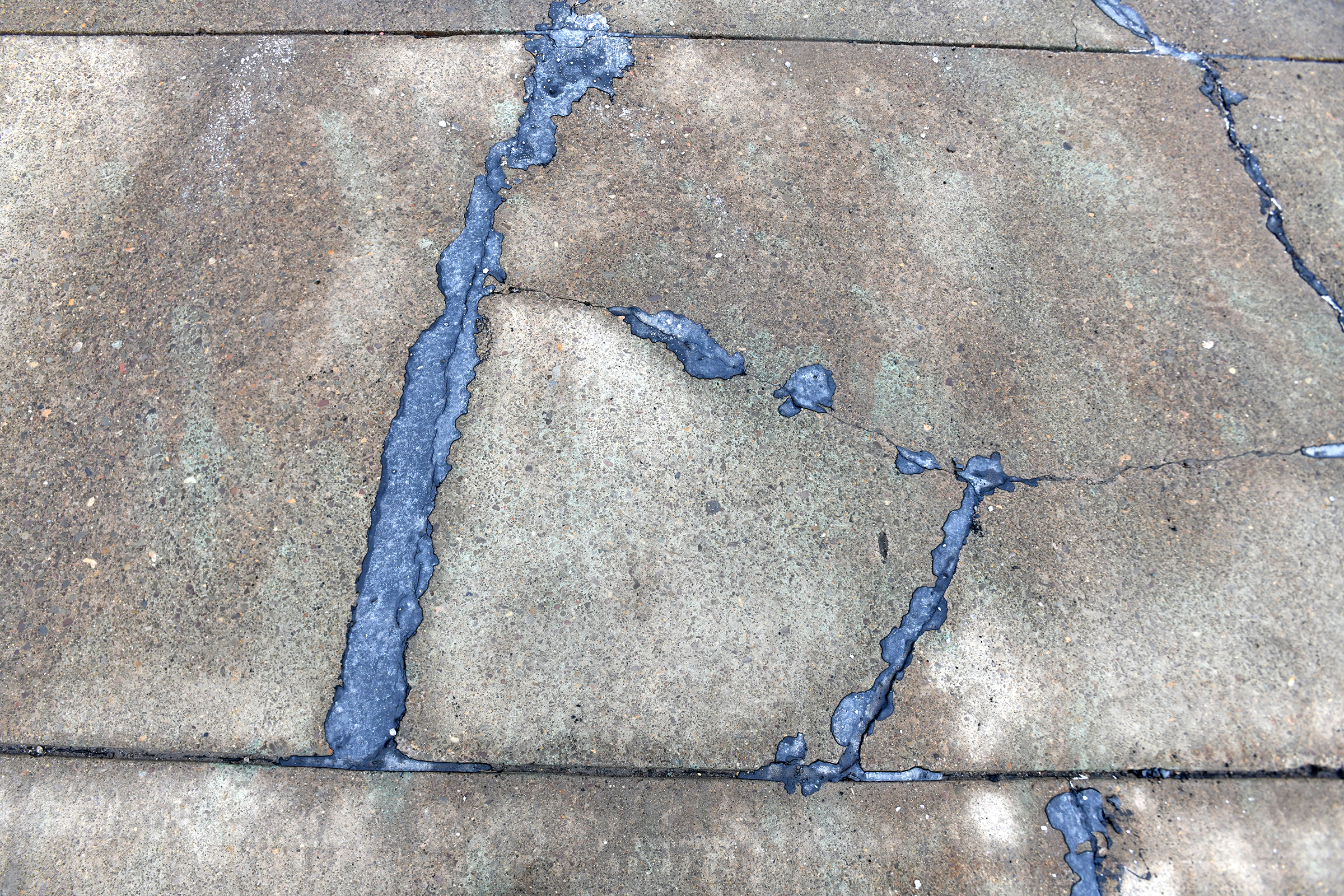 A vinyl concrete patch mix fills in the cracks on...