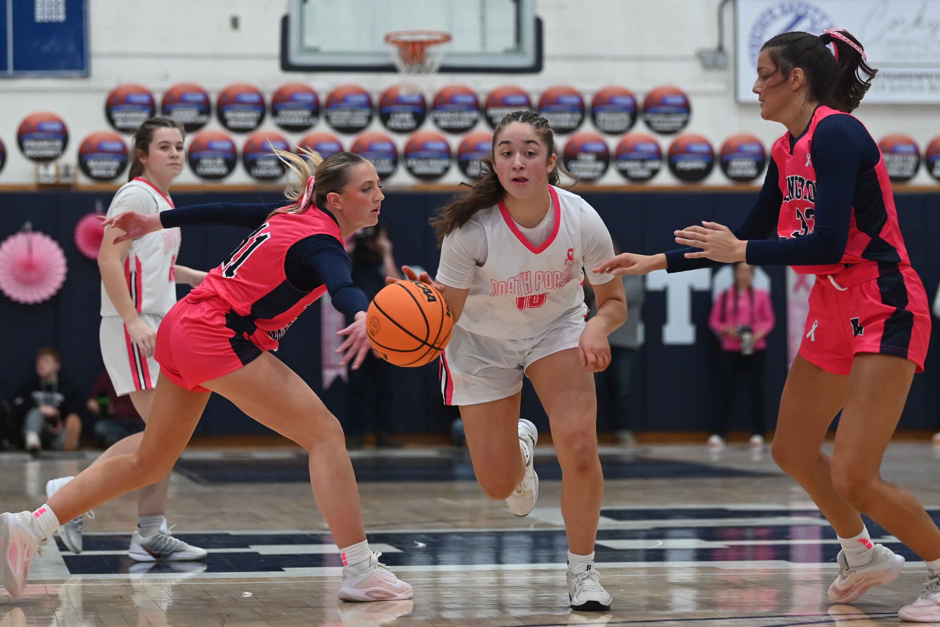 North Pocono’s Ella Clementoni drives between Abby Schneider, left, and...