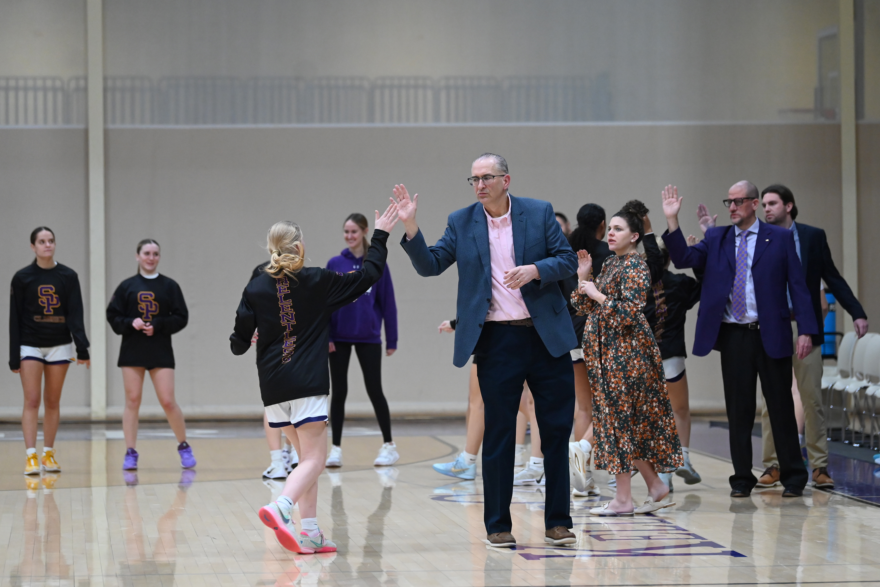 Scranton Prep’s Bob Beviglia high fives his players before the...