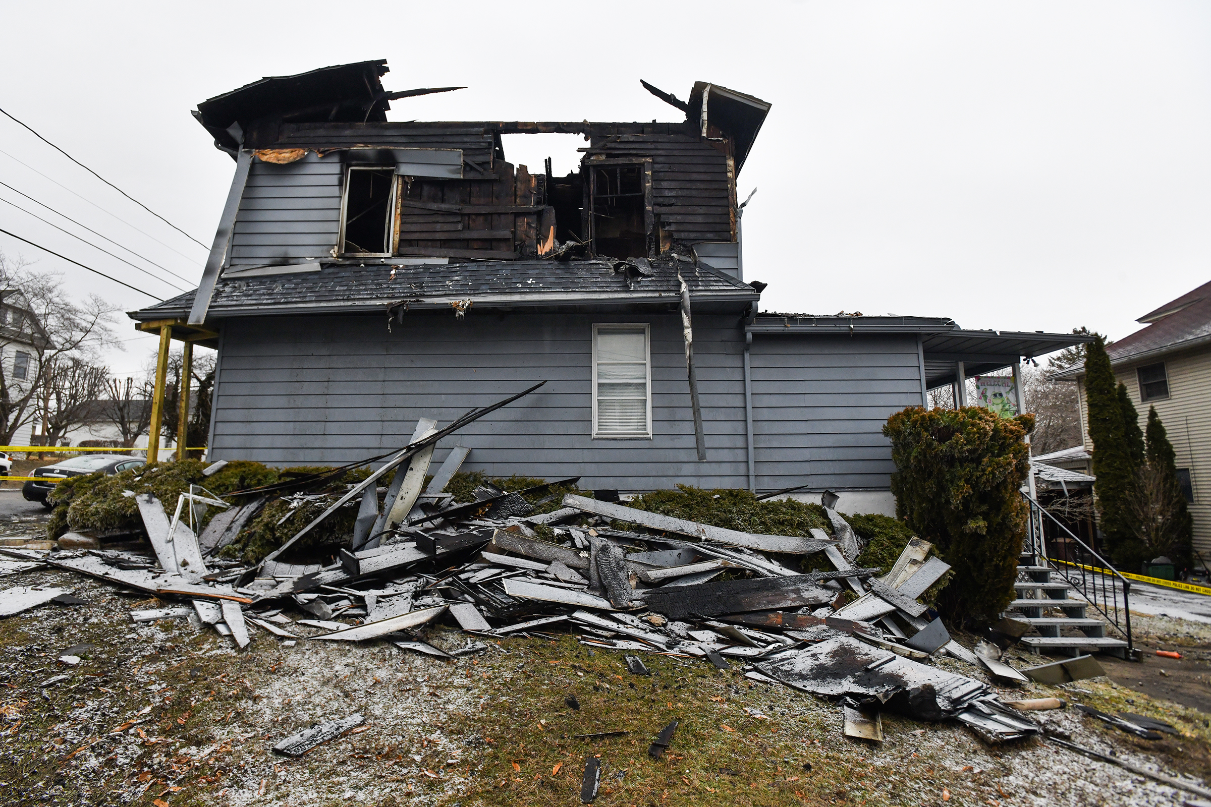 Sections of a roof lay on the ground from a...