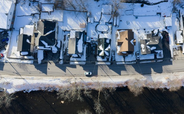 A vehicle passes by homes on N. Main St. in Archbald Friday, February 13, 2026. (SEAN MCKEAG / STAFF PHOTOGRAPHER)