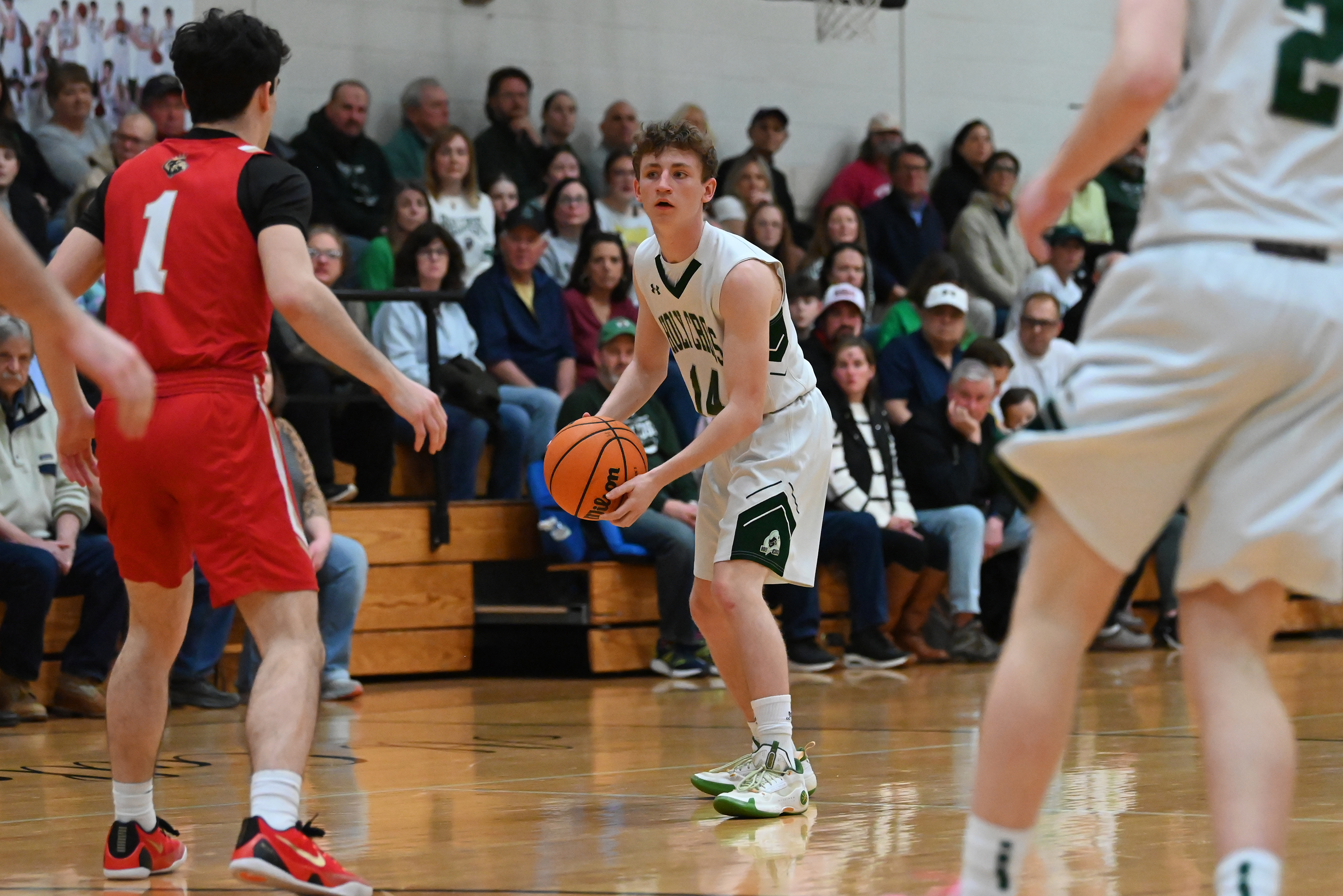 Holy Cross’ Colin Farrell controls the ball during the basketball...