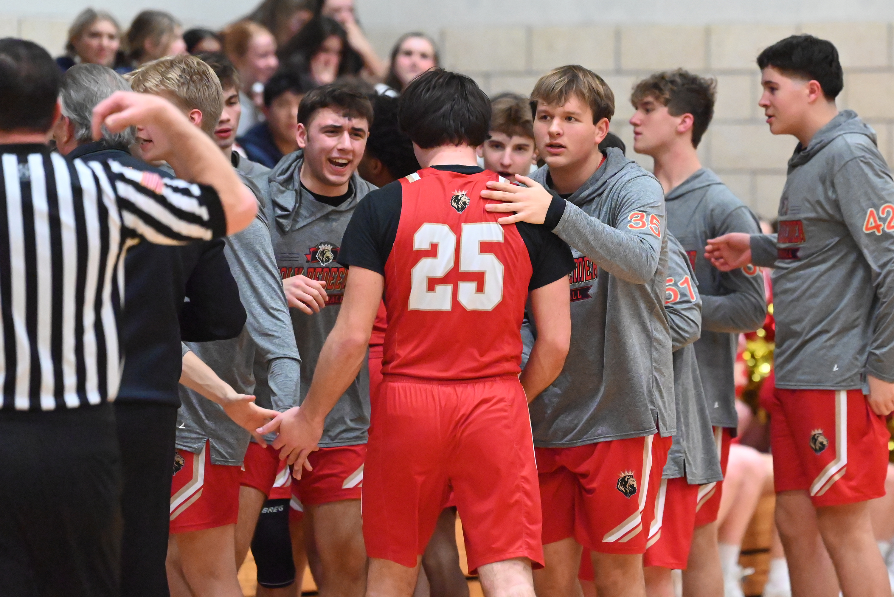 Holy Redeemer players welcome Kaden Sepkoski back to the bench...