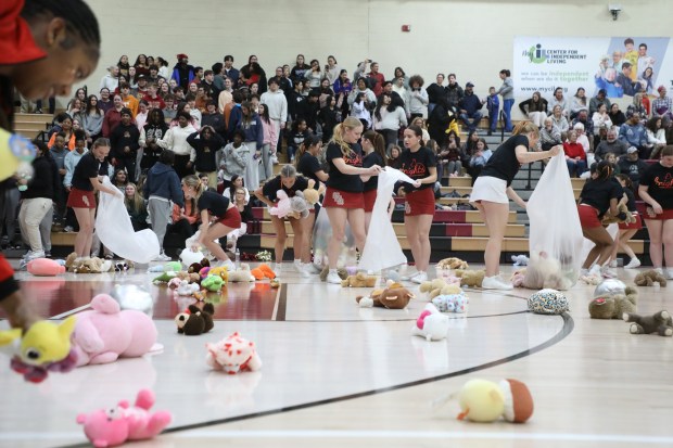Scranton cheerleaders collect the stuffed animals tossed from the stands during the basketball game at Scranton High School in Scranton on Thursday, Feb. 05, 2026. (REBECCA PARTICKA/STAFF PHOTOGRAPHER)