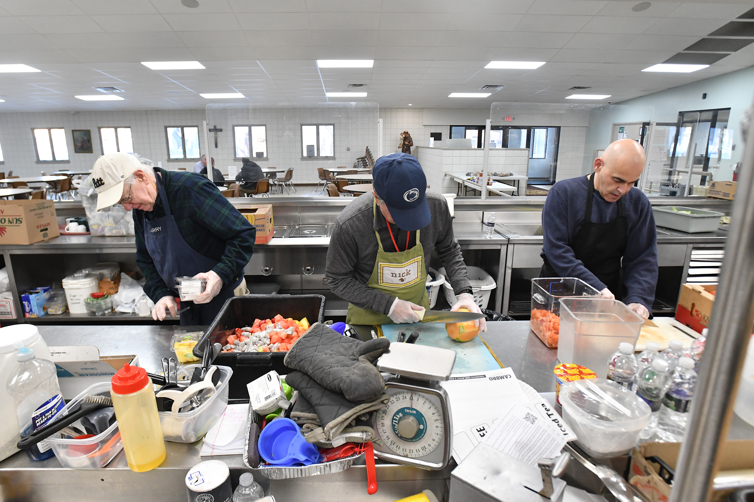 Volunteers Jerry Burns, Nick Donato and Alexis Ramos prepare for...