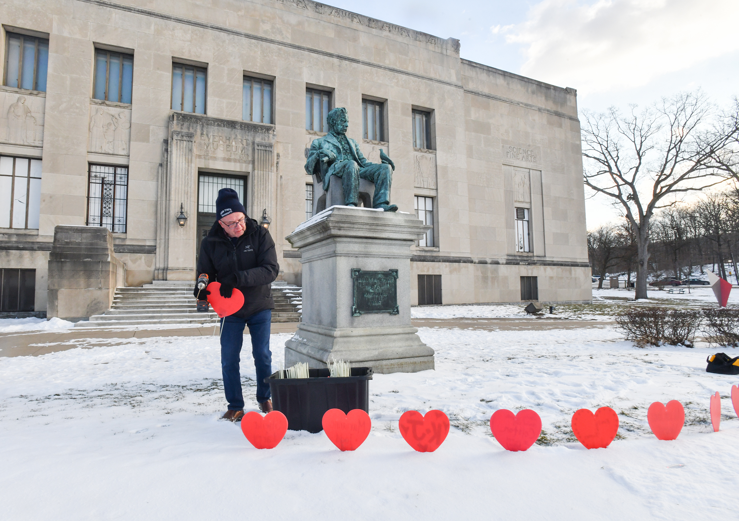 Scranton resident Frank Dubas installs hearts inscribed with names and...