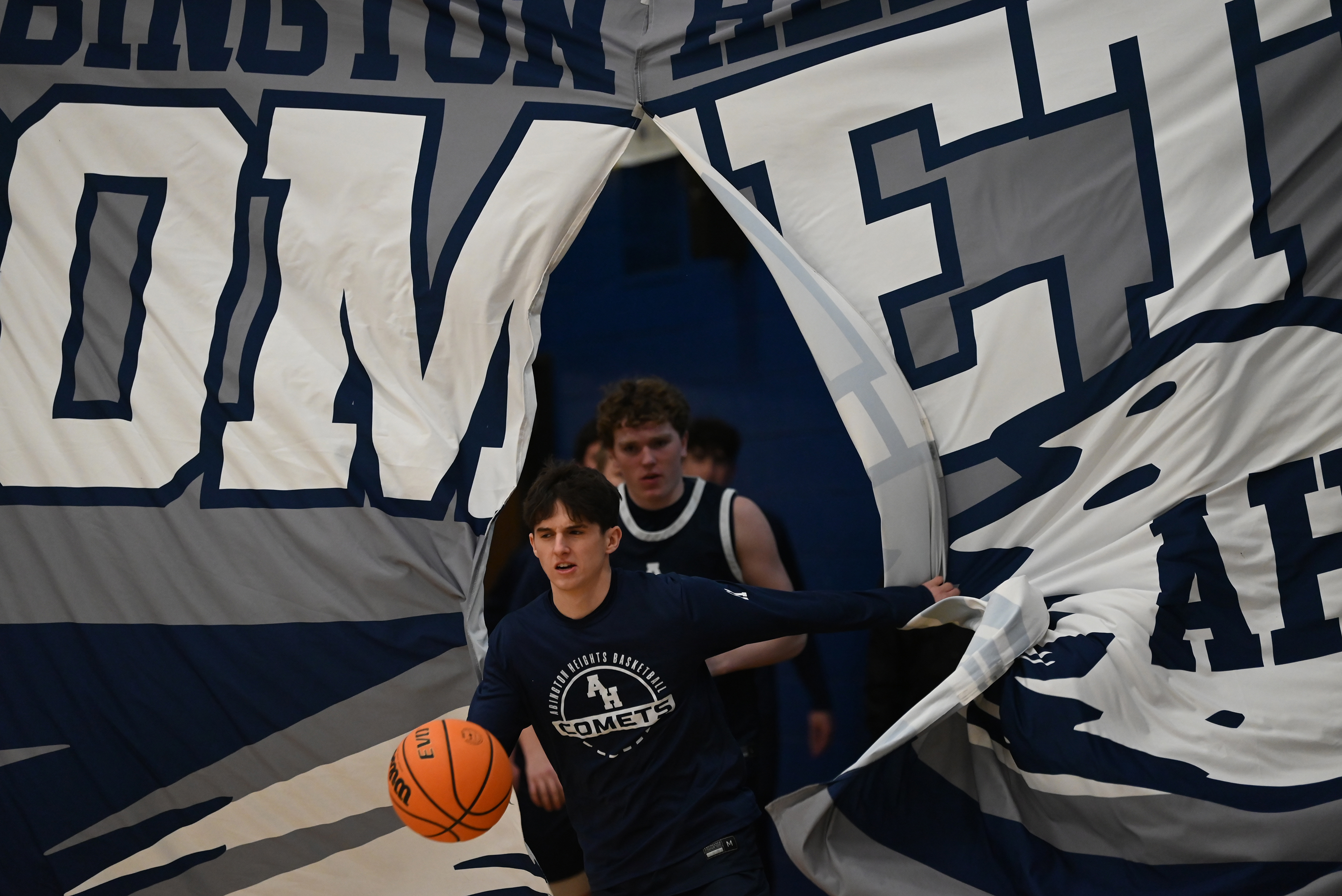 The Abington Heights team runs onto the court before the...