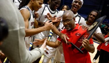 Imhotep Institute Charter players celebrate with their head coach Andre Noble after winning the PPL Boys Basketball Championship.