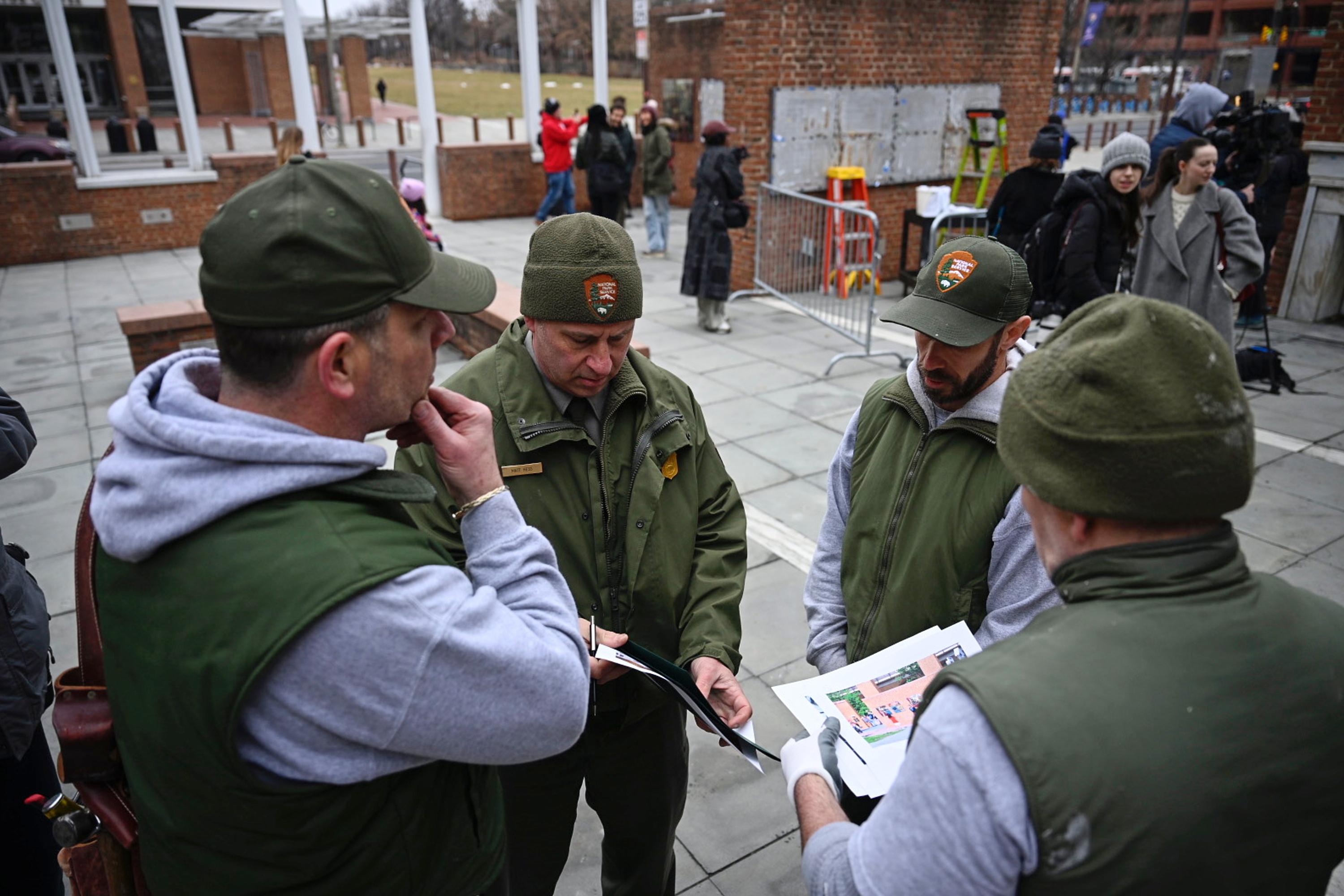 National Parks Service workers gather as panels that were part...