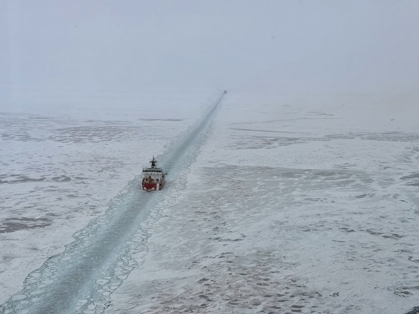 The U.S. Coast Guard Cutter Mackinaw carves a path through ice-covered Lake Michigan while responding to a vessel trapped in the ice last week in the Straits of Mackinac.