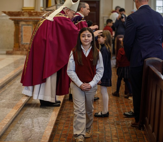 Allentown Bishop Alfred A. Schlert places ashes on the forehead of a student from St. John Vianney Regional School during Ash Wednesday Mass on Wednesday, Feb. 18, 2026, at the Cathedral of St. Catharine of Siena in Allentown. (Jane Therese/Special to The Morning Call)