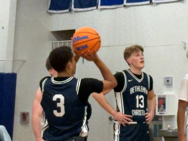 Bethlehem Christian's Myles Harris shoots a free throw in a game against Coventry Christian on Friday night. Teammate Caleb Brown, 13, takes his position along the lane for the foul shot. (Keith Groller/The Morning Call)